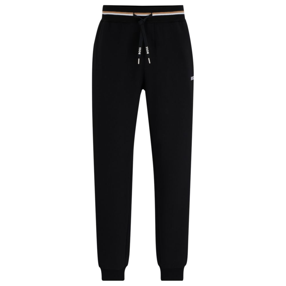 Tracksuit bottoms with stripes and logos